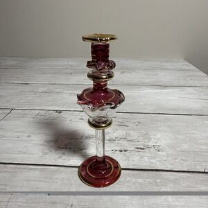 Vintage cranberry glass perfume bottle with gold accents.